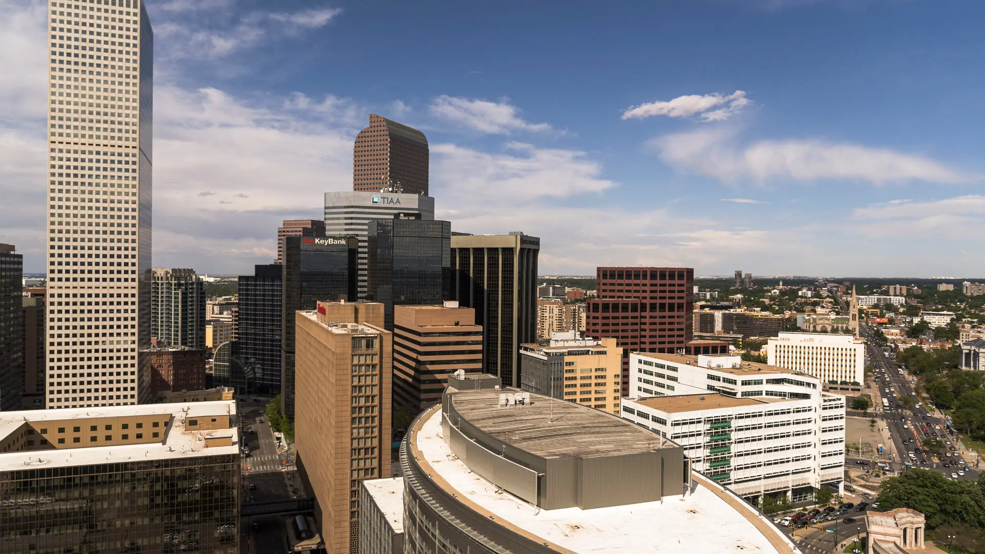 Denver cityscape with skyscrapers under blue sky.