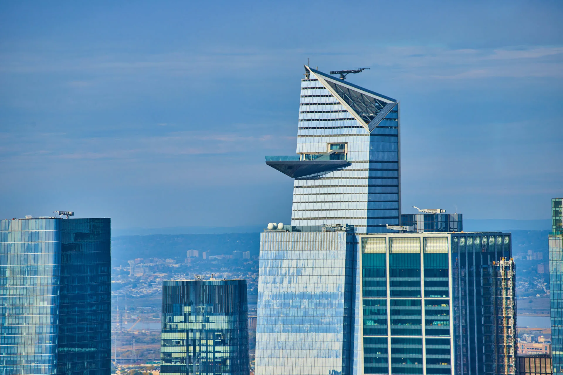 Skyscraper with observation deck and city skyline.